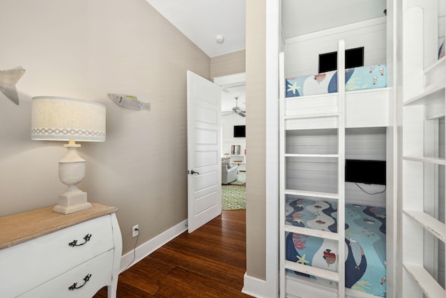 hallway with baseboards and dark wood finished floors