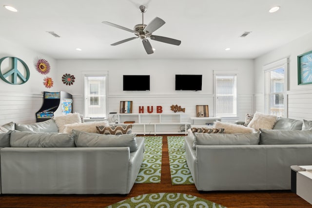 living room with a wainscoted wall, recessed lighting, visible vents, and ceiling fan