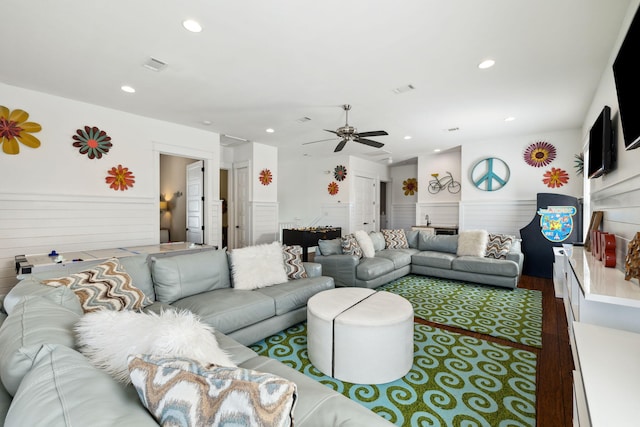 living room featuring a wainscoted wall, visible vents, a ceiling fan, wood finished floors, and recessed lighting