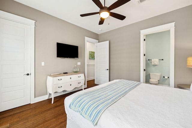 bedroom featuring baseboards, visible vents, dark wood finished floors, ceiling fan, and ensuite bathroom