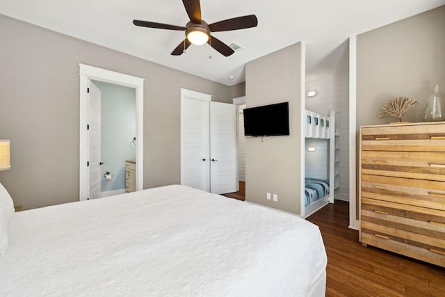 bedroom featuring ceiling fan, dark wood finished floors, and ensuite bathroom