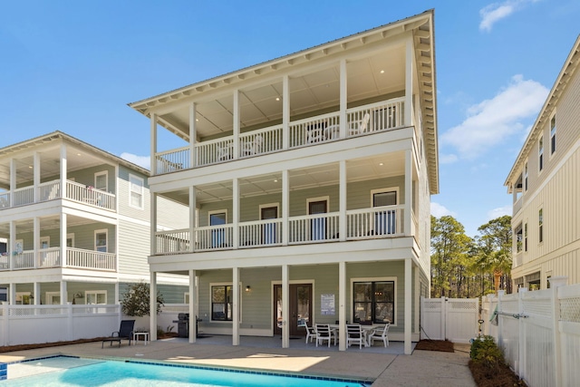 back of house with a gate, a fenced in pool, a patio, and fence