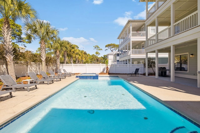 view of pool with area for grilling, a patio area, a fenced in pool, and a fenced backyard