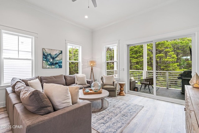 living room with recessed lighting, light wood-style flooring, crown molding, and a ceiling fan