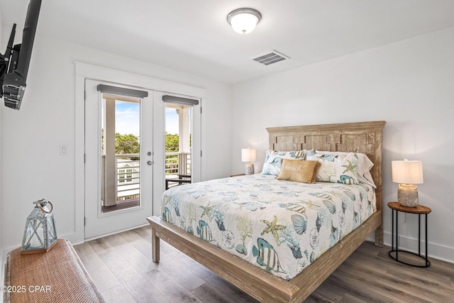 bedroom with access to outside, wood finished floors, visible vents, and french doors