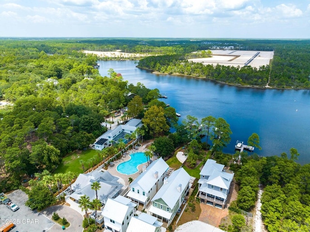 birds eye view of property featuring a wooded view and a water view