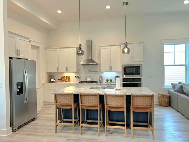150 Grande Pointe Cir, Inlet Beach, FL 32461 - kitchen featuring stainless steel appliances, wall chimney range hood, backsplash, a sink, and white cabinetry