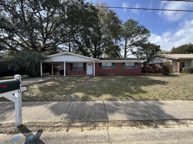 single story home with brick siding, driveway, a carport, and a front yard