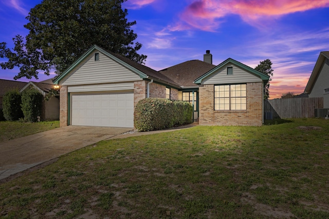 ranch-style home with brick siding, an attached garage, fence, a front yard, and driveway