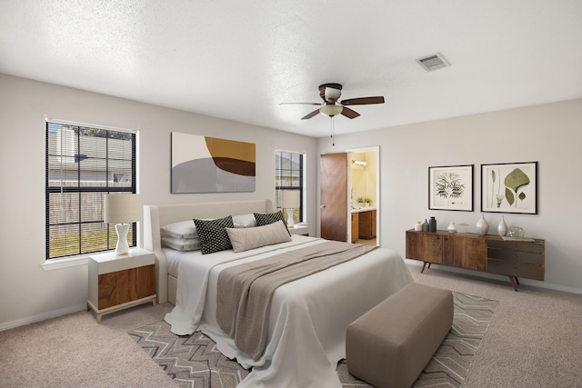 bedroom featuring visible vents, multiple windows, light colored carpet, and baseboards