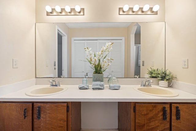 full bathroom featuring a sink and double vanity