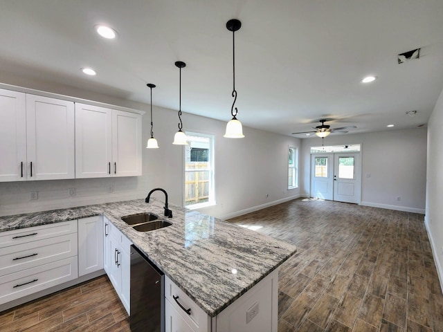 kitchen featuring dark wood-type flooring, dishwasher, a peninsula, white cabinets, and a sink