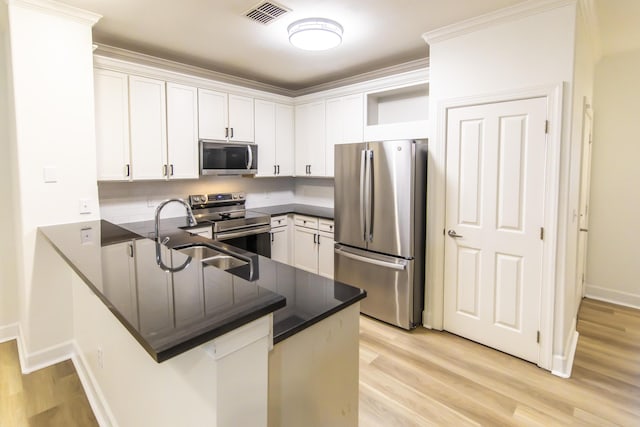 kitchen with dark countertops, visible vents, appliances with stainless steel finishes, a peninsula, and open shelves