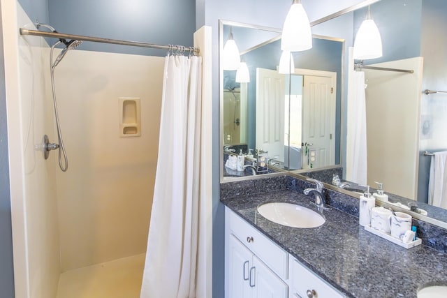 bathroom with vanity and a stall shower