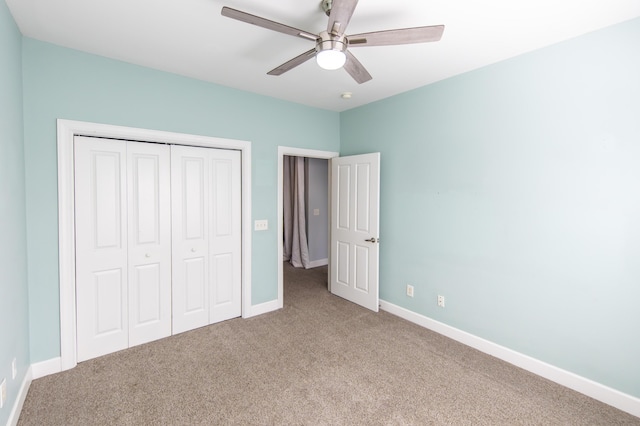 unfurnished bedroom with a closet, a ceiling fan, baseboards, and carpet floors