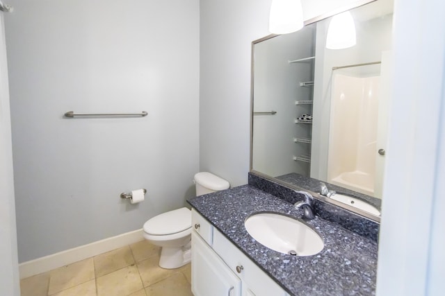 bathroom with tile patterned floors, toilet, a shower, baseboards, and vanity