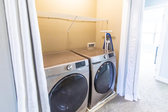 clothes washing area featuring baseboards, carpet, independent washer and dryer, and laundry area