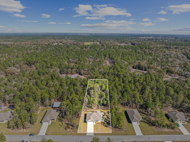 drone / aerial view featuring a view of trees