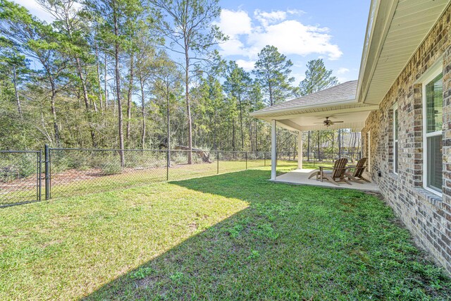 view of yard with a patio, a fenced backyard, and ceiling fan