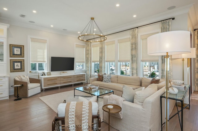 living area featuring plenty of natural light, wood finished floors, and visible vents