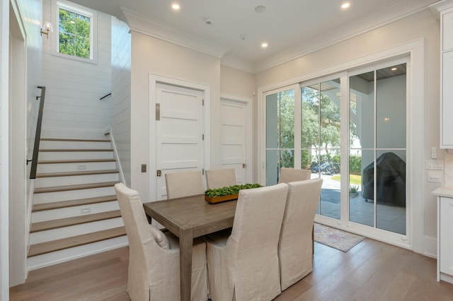 dining area with crown molding, stairway, recessed lighting, and light wood finished floors