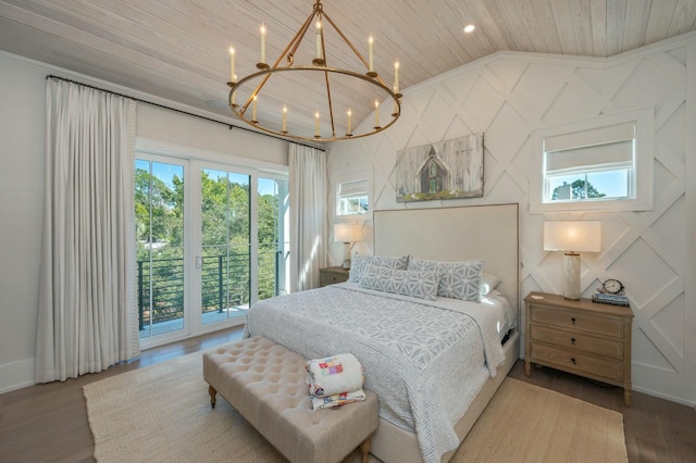 bedroom with a notable chandelier, wood finished floors, wooden ceiling, access to exterior, and vaulted ceiling