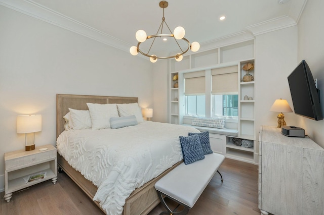 bedroom with a chandelier, recessed lighting, ornamental molding, and wood finished floors