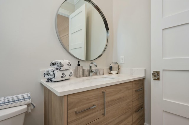 half bath featuring toilet and vanity