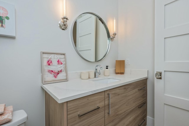 bathroom featuring toilet and vanity