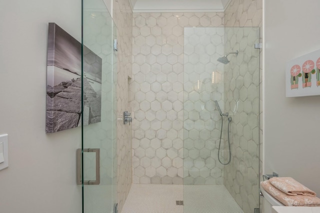 bathroom with a shower stall and toilet