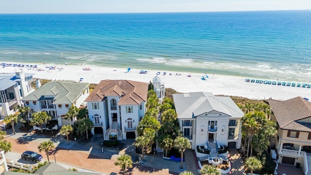 drone / aerial view with a view of the beach, a water view, and a residential view