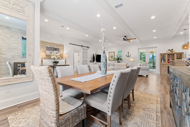 dining room with visible vents, recessed lighting, a barn door, french doors, and light wood-style floors