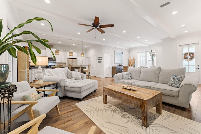 living area with visible vents, beamed ceiling, a ceiling fan, recessed lighting, and light wood-style floors