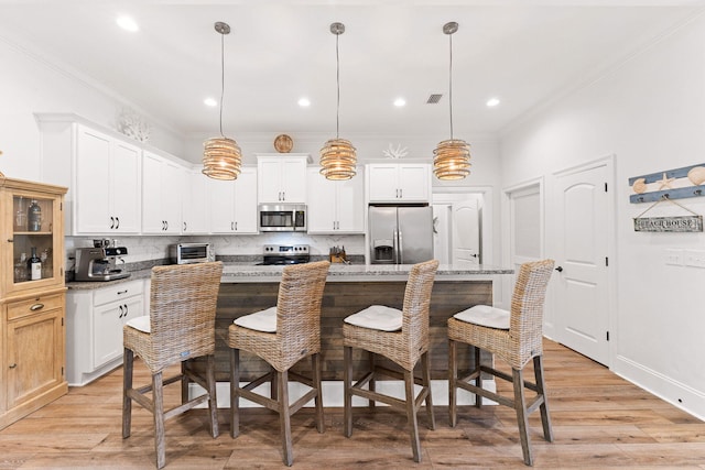 kitchen featuring a toaster, white cabinets, and appliances with stainless steel finishes