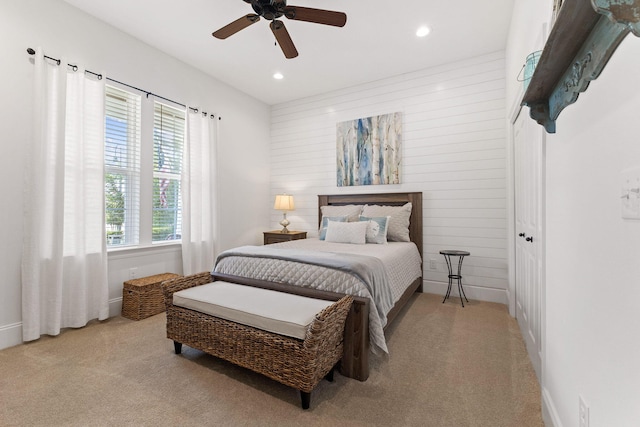 carpeted bedroom featuring recessed lighting, wood walls, and ceiling fan