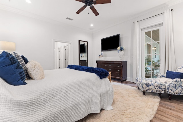 bedroom with visible vents, crown molding, recessed lighting, wood finished floors, and access to outside