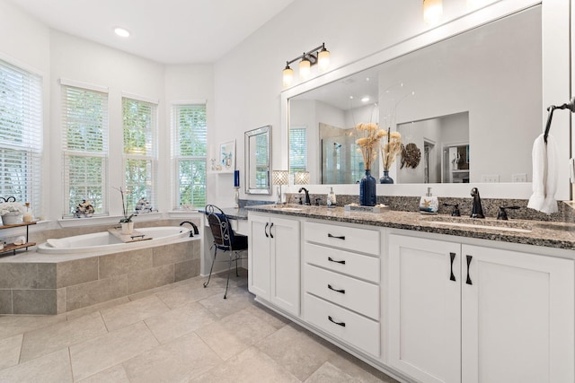 bathroom with a sink, a stall shower, and a wealth of natural light