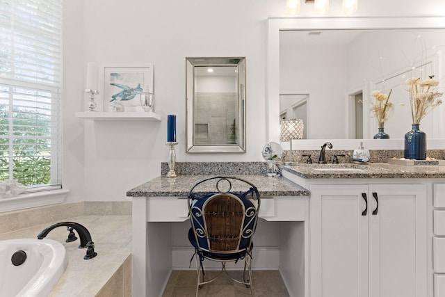 bathroom featuring vanity, a garden tub, and tile patterned floors