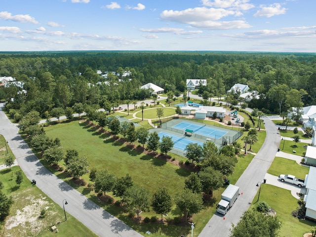 birds eye view of property featuring a view of trees