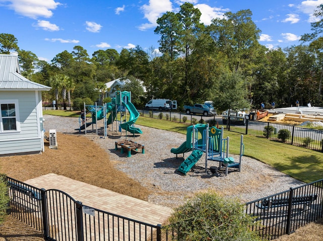 community play area featuring a lawn and fence