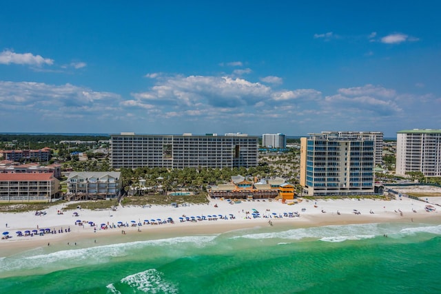 birds eye view of property featuring a city view, a view of the beach, and a water view