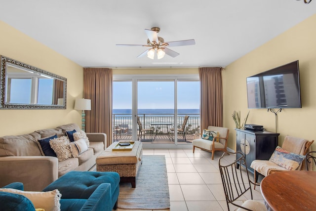 living area with light tile patterned floors and a ceiling fan