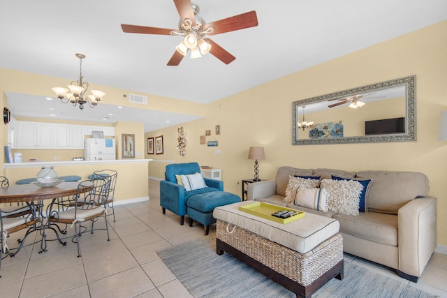 living area featuring light tile patterned floors, visible vents, baseboards, and ceiling fan with notable chandelier