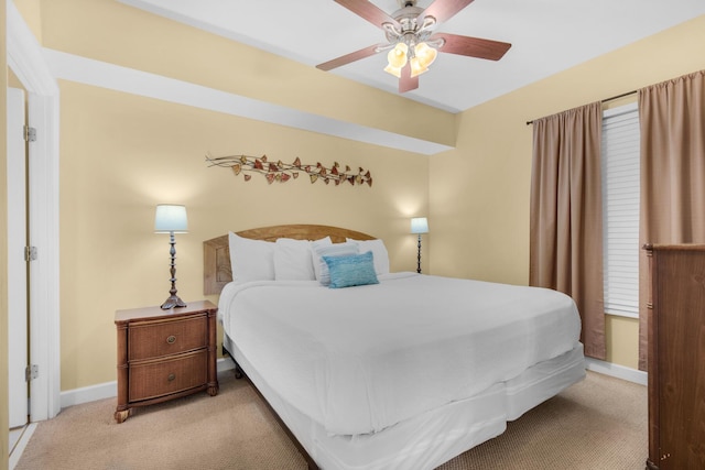 carpeted bedroom featuring ceiling fan and baseboards