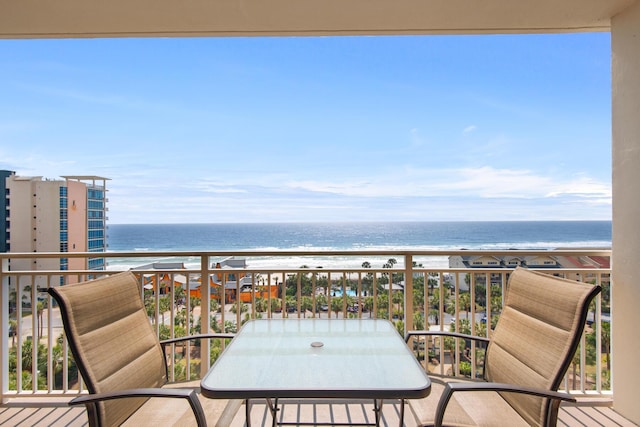 balcony featuring a water view and a beach view