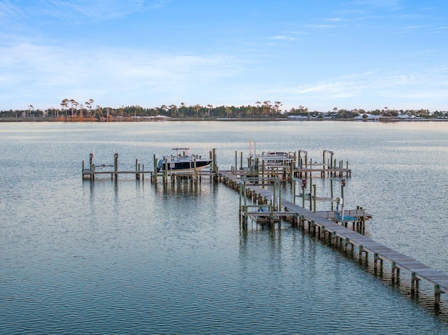 view of dock with boat lift and a water view