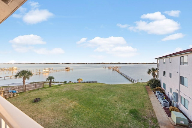 view of yard featuring cooling unit and a water view