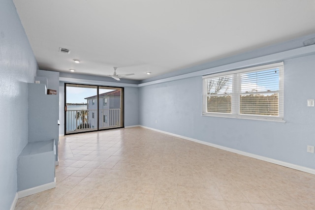 unfurnished room with visible vents, baseboards, and ceiling fan