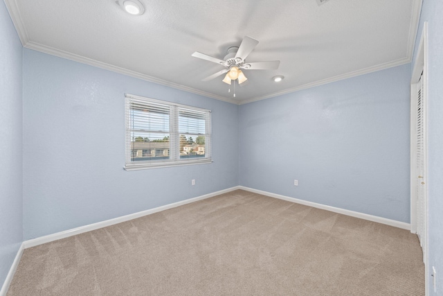 unfurnished room with ceiling fan, baseboards, light colored carpet, and ornamental molding