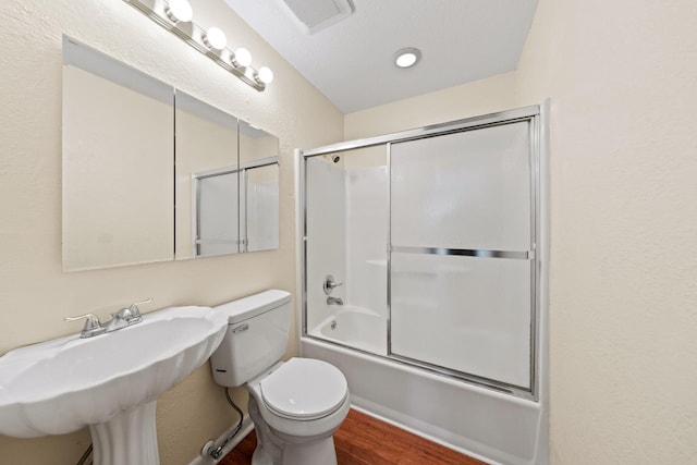 full bathroom featuring wood finished floors, visible vents, a sink, toilet, and combined bath / shower with glass door